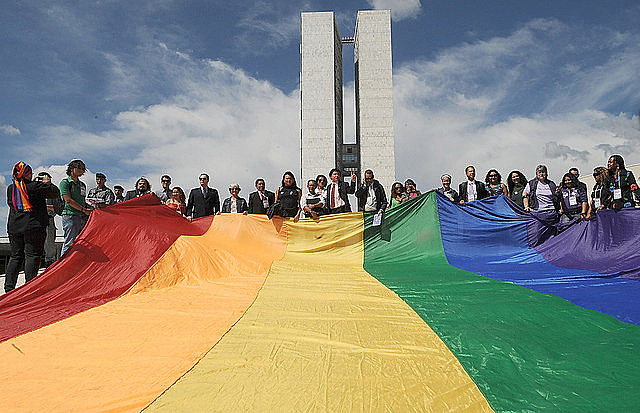 LGBT activists hold rainbow flag outside Brazil’s Congress during the country’s first March Against Homophobia