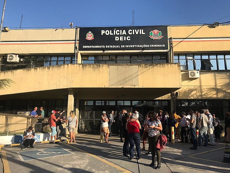 Integrantes de movimentos de moradia aguardam do lado de fora do DEIC