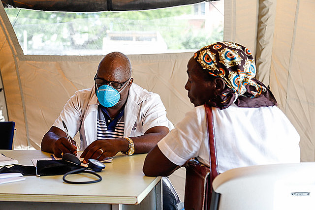 A doctor sees a Mozambican patient in one of the seven basic health care tents of a temporary camp in Beira